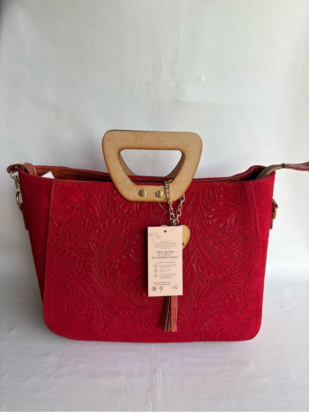 Artisanal Red Floral Embossed
Tote with Wood Handle and Tassel
Genuine Leather